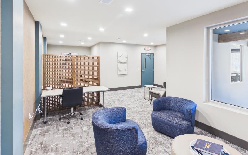 a room with blue chairs and a table