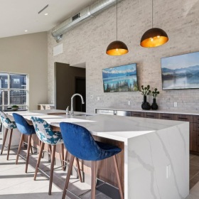 a kitchen with a bar and chairs