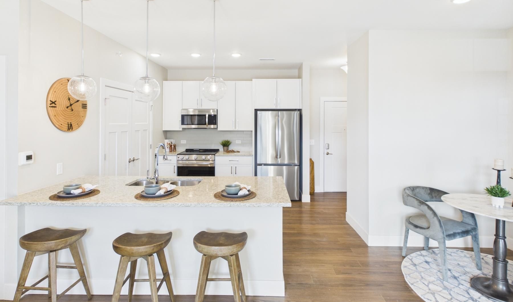 a kitchen with a table and chairs