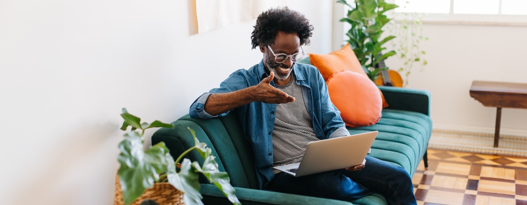 a person sitting on a couch with a laptop