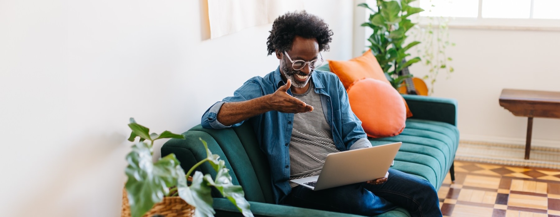 a person sitting on a couch with a laptop