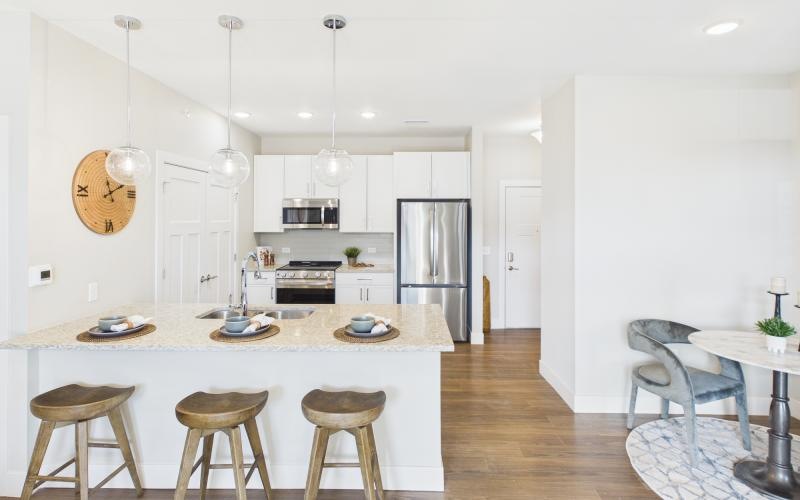 a kitchen with a table and chairs